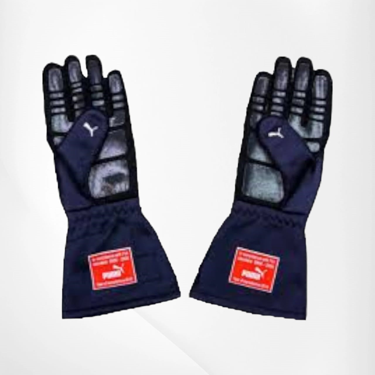 Pair of navy blue racing gloves with red Puma labels on a white background